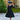 Woman posing in black embossed floral 1950s swing dress with matching bolero jacket and wide hat