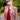 Blonde woman wearing wine red cable knit tank top layered under claret check suit jacket