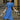 Woman in 1940s blue swing dress wearing white hat with veil, long gloves, and heels