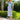 Woman in 1940s blue and cream gingham linen-blend skirt suit wearing straw hat