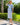 Woman in 1940s blue and cream gingham linen-blend skirt suit wearing straw hat