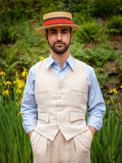 Man in straw hat wearing cream Gadabout waistcoat and light blue shirt