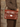 Model in a brown tweed jacket wearing the handmade tan leather satchel bag over the shoulder