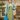 Three-quarter view of woman wearing retro sage floral shirt dress paired with pastel coat and beret