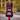 Model wearing maroon flecked Sunday Best swing coat styled with magenta tights and a matching handbag outdoors
