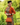 Mid shot of model in 1950s sunset orange cardigan styled with matching handbag and hat