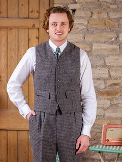Man wearing grey houndstooth Clubman waistcoat with white collared shirt and green tie