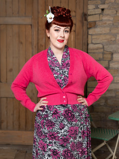 Woman in pink Daydream cardigan and 1940s floral Lovers Lane Twilight tea dress