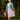 Woman wearing 1940s Lumber Jill check day dress in pink plaid with teal cardigan and suitcase