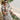 Woman wearing 1950s Cream Tahiti Hawaiian print shirtwaister dress with straw hat and bangles