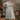 Woman in 1940s Floral Tribute Tea Dress in Daisy Bubble print with hand on hip, front view