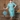 Redhead woman posing in 1940s seafoam polka dot skirt suit holding vanity case