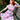 Woman seated wearing 1950s style Pink Floral Bouquet day dress with white contrast belt