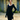 Woman in 1950s blue velvet wiggle dress with gloves, pillbox hat, and handbag